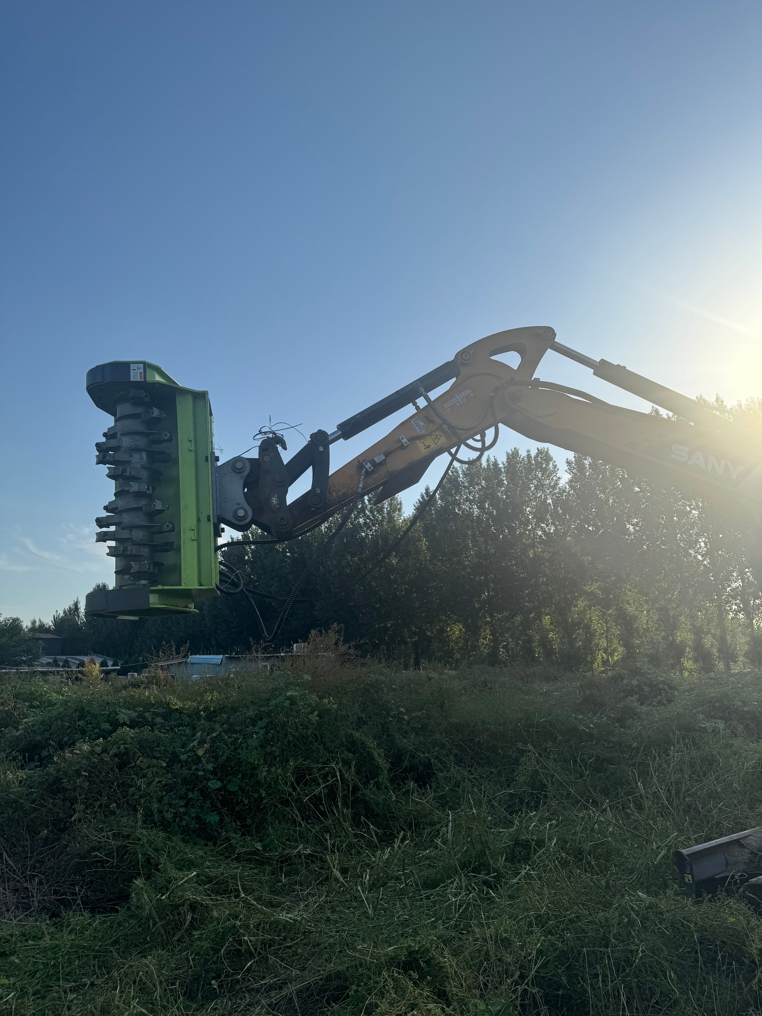PANDA FORCE Excavator Brush Cutter mounted on excavator arm — field working shot