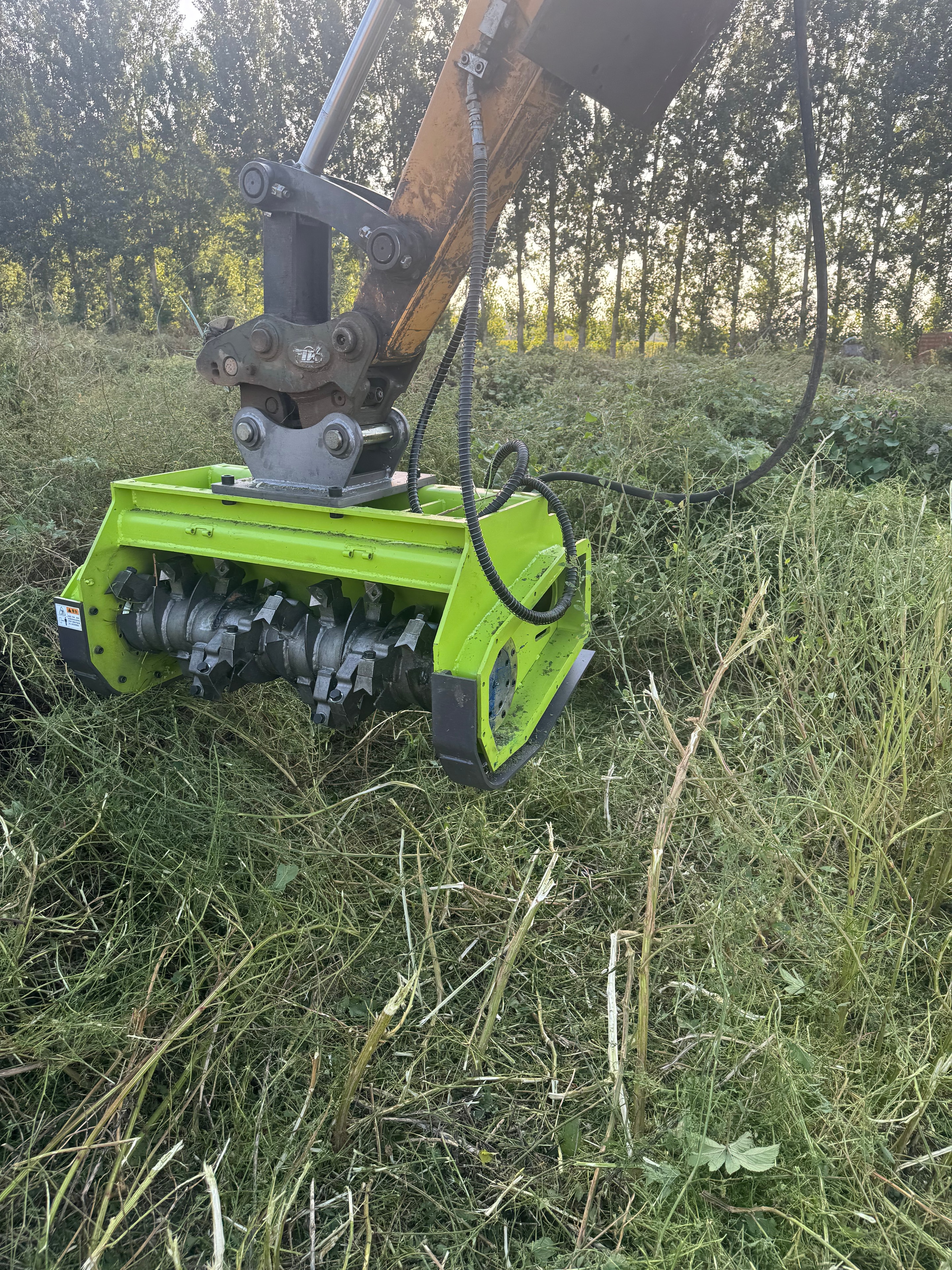 Excavator Brush Cutter cutting dense vegetation — overhead view
